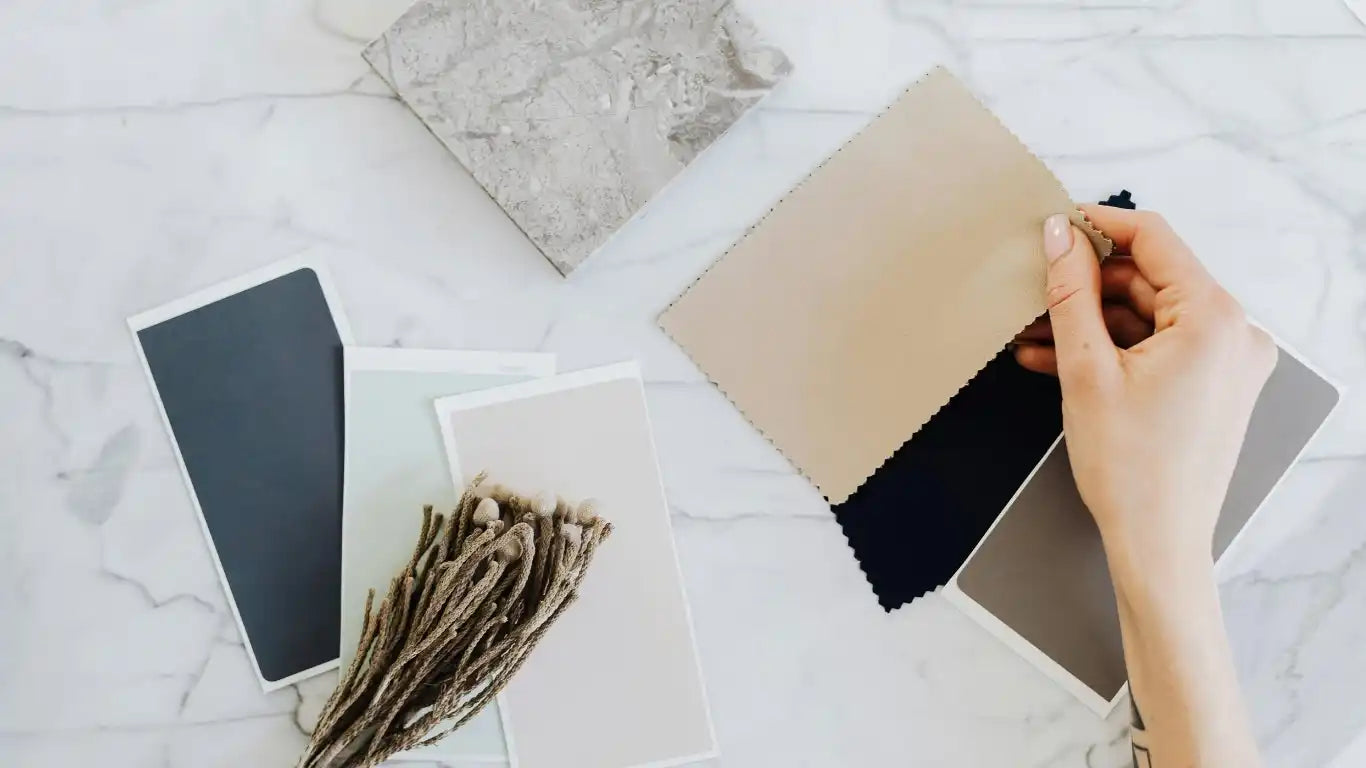 Beige leather texture swatch cardholder with metallic accents.