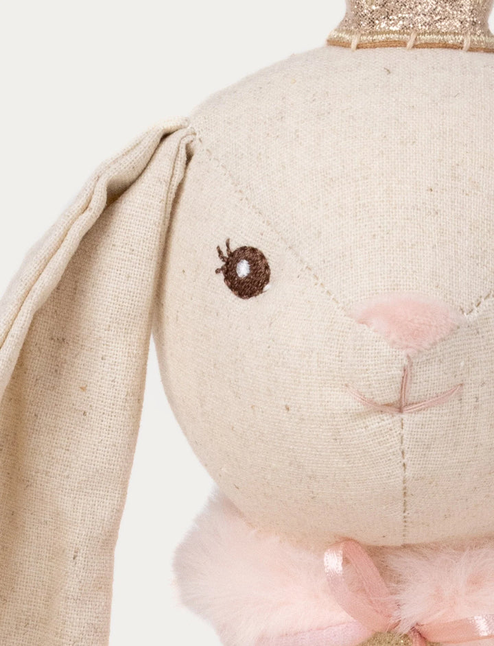 Close-up of Ballerina Bunny Line plush toy’s embroidered face with pink nose, gold crown, and fluffy collar detail, Baby Belle.