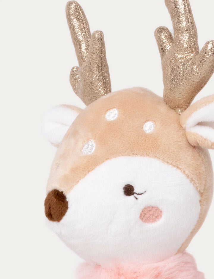 Close-up of Ballerina reindeer Ruth plush toy’s embroidered face with blush cheeks, gold antlers, and soft velvet texture, Baby Belle.