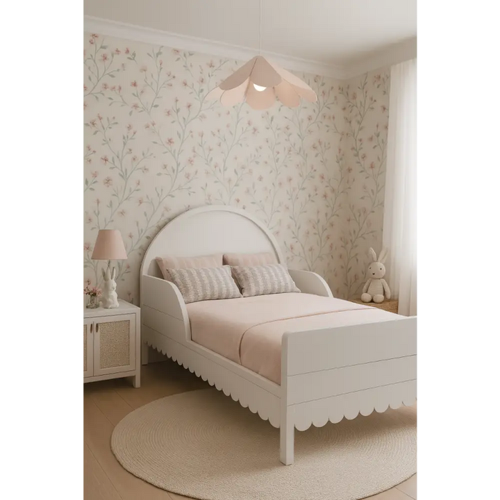 Children's bedroom with a white bed, floral wallpaper, and decorative elements.
