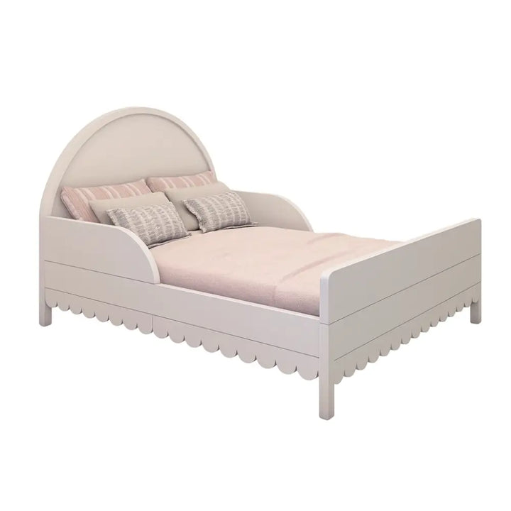 The Petal Bed by Baby Belle in double size — white children’s bed with scalloped edges and soft pink bedding