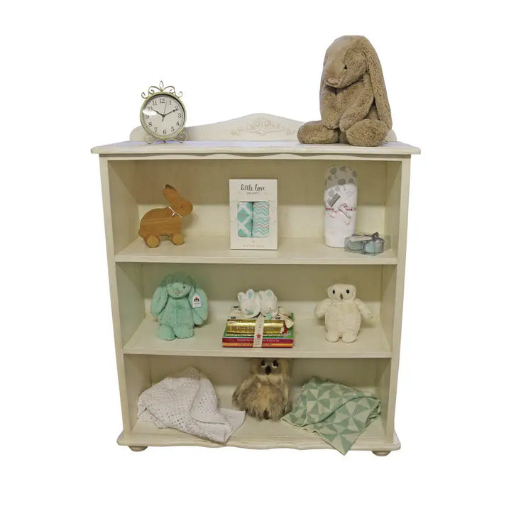 Handcrafted French-style bookshelf with carved crest and three open shelves, painted in non-toxic finish, ideal for nursery or children’s room
