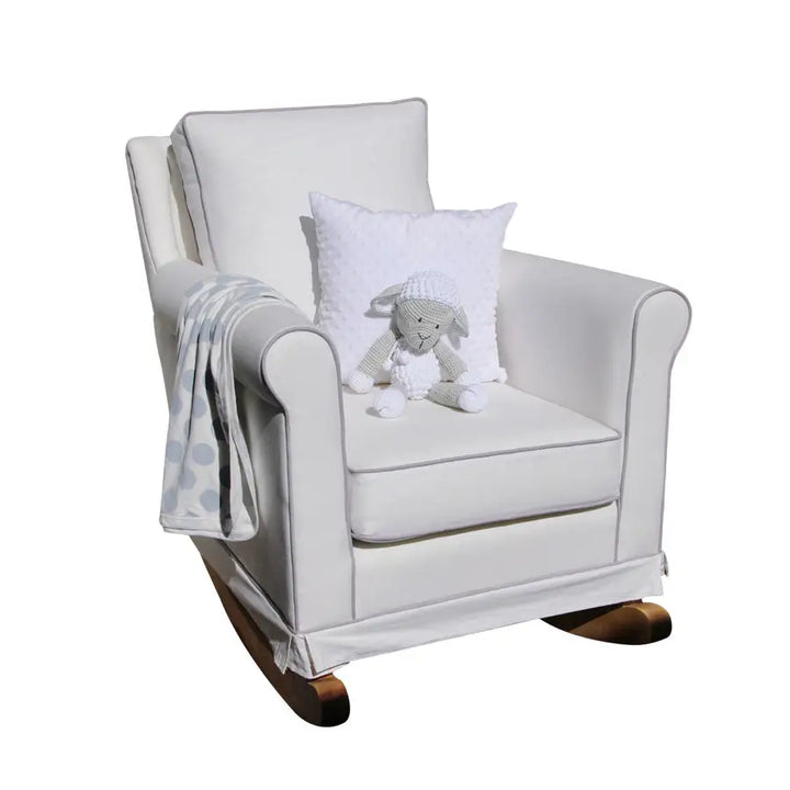 Tres Chic Rocking Chair in white with solid wooden rocking legs, featuring a plush cushioned seat styled with a toy lamb and throw blanket.