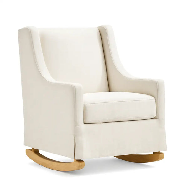 A cream-colored upholstered rocking chair with smooth armrests, a cushioned seat, and natural wooden rocker legs, placed against a white background.
