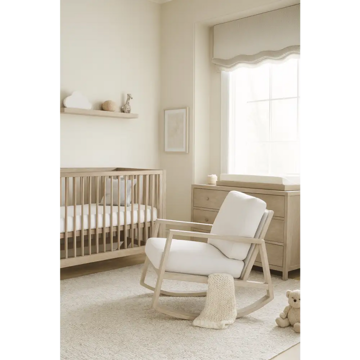 Baby Belle Harvey Rocking Chair with solid French oak frame and white cushions, styled in a luxury neutral nursery with cot and dresser – handcrafted nursing and feeding chair South Africa