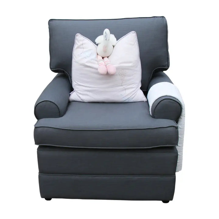 A front view of the Jetaime Chair, upholstered in rich charcoal fabric. The chair features a high cushioned backrest, soft rolled arms, and a deep padded seat, combining comfort with an elegant, timeless nursery style.