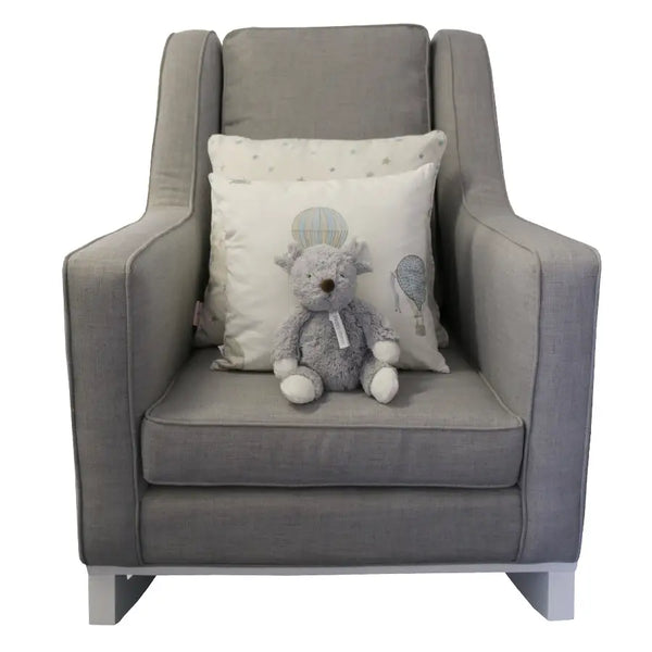The Mathew Rocking Chair from Baby Belle, upholstered in grey fabric with a modern wingback design, padded seat, and wooden rocking base, crafted for comfort and style in the nursery or living space.