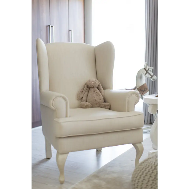 Baby Belle Oliver Feeding Chair in cream fabric with classic wingback design and Queen Anne legs, luxury nursing and feeding chair handcrafted in South Africa.