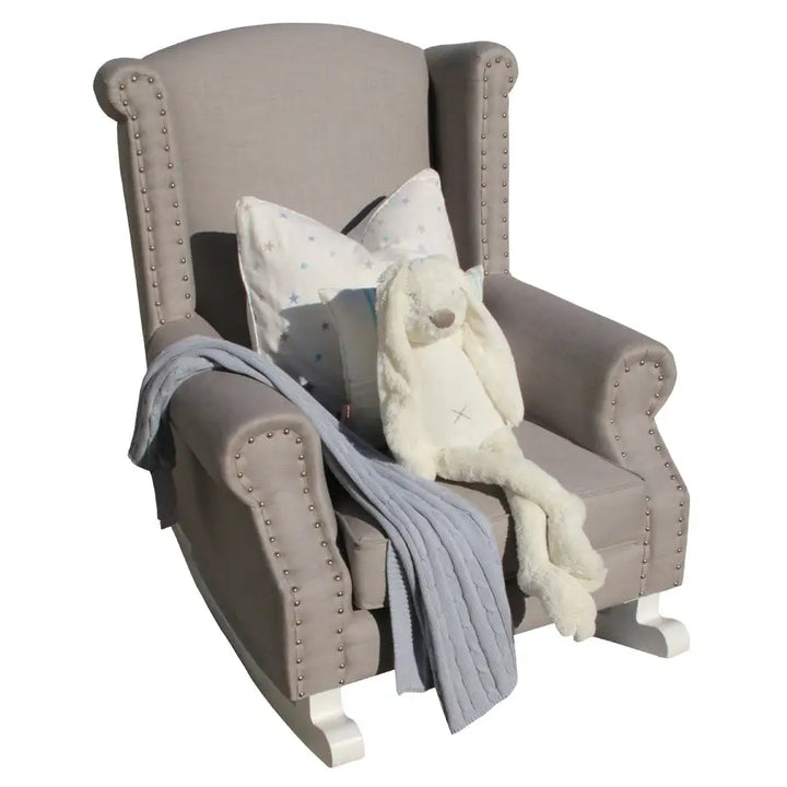 Baby Belle Romeo Rocking Chair in grey fabric with stud detailing and white painted wooden rocking legs, classic wingback nursing and feeding chair handcrafted in South Africa.