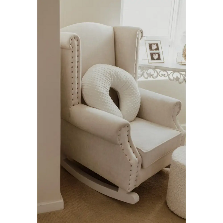 Baby Belle Romeo Rocking Chair in cream fabric with stud detailing and white painted wooden rocking legs, classic wingback nursing and feeding chair handcrafted in South Africa.