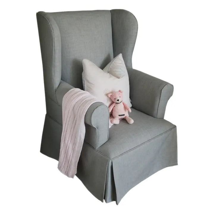photo featuring the Baby Belle Rose Feeding Chair with slipcover and ottoman, elegant wingback nursing chair with pleated skirt design, handcrafted in South Africa.